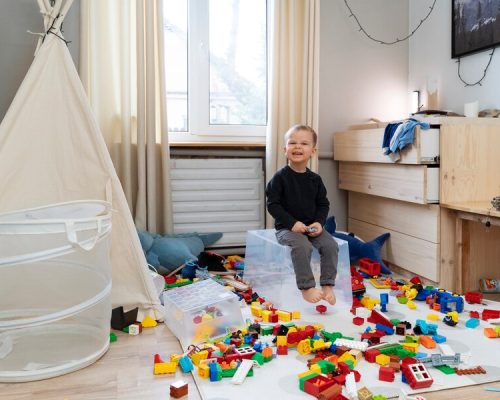 full-shot-smiley-kid-sitting-container_23-2149311327